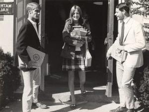 Female 全球十大网赌正规平台 student with books leaving Mather Hall at registration time, 1969.
